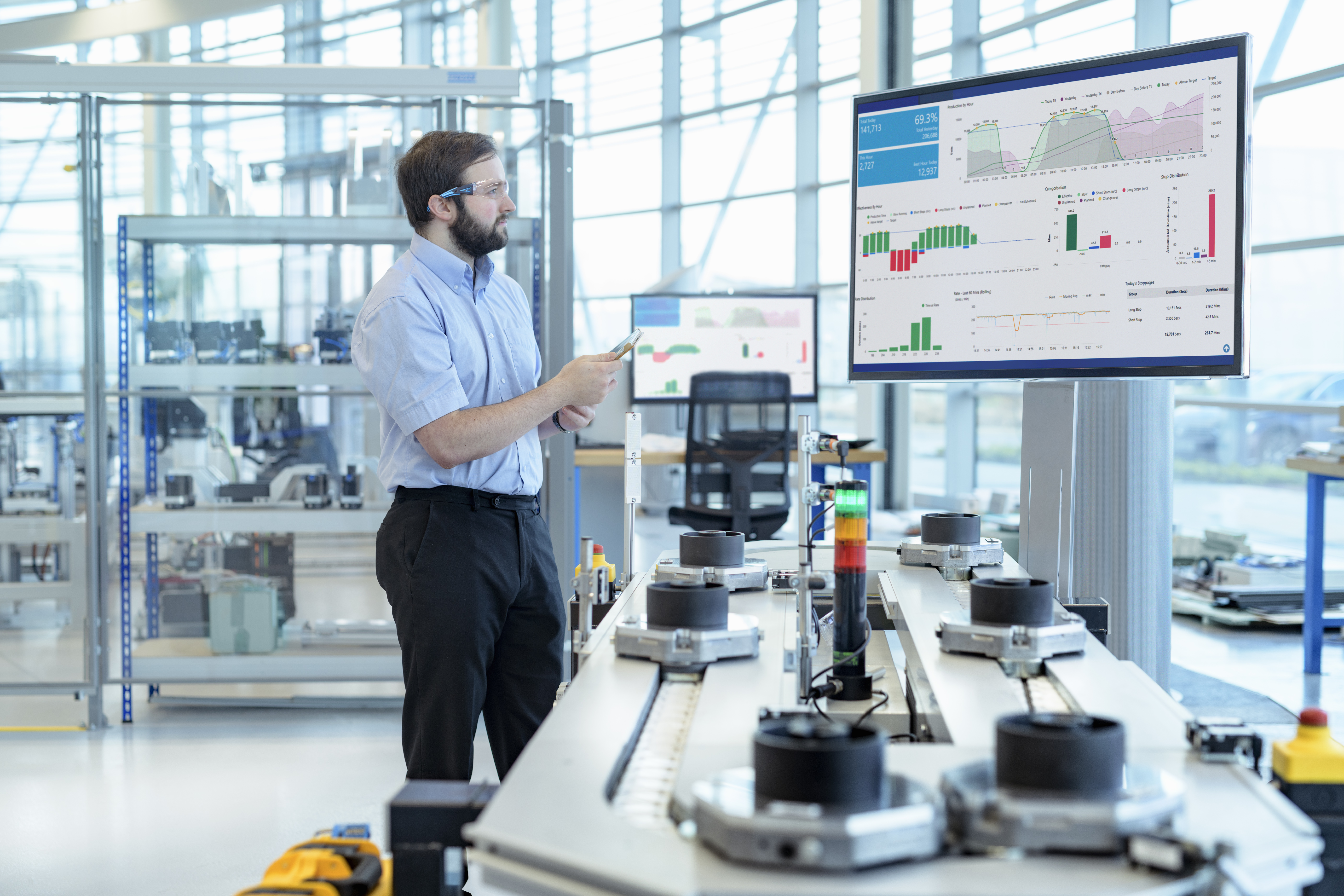 Engineer testing a robotic production simulator