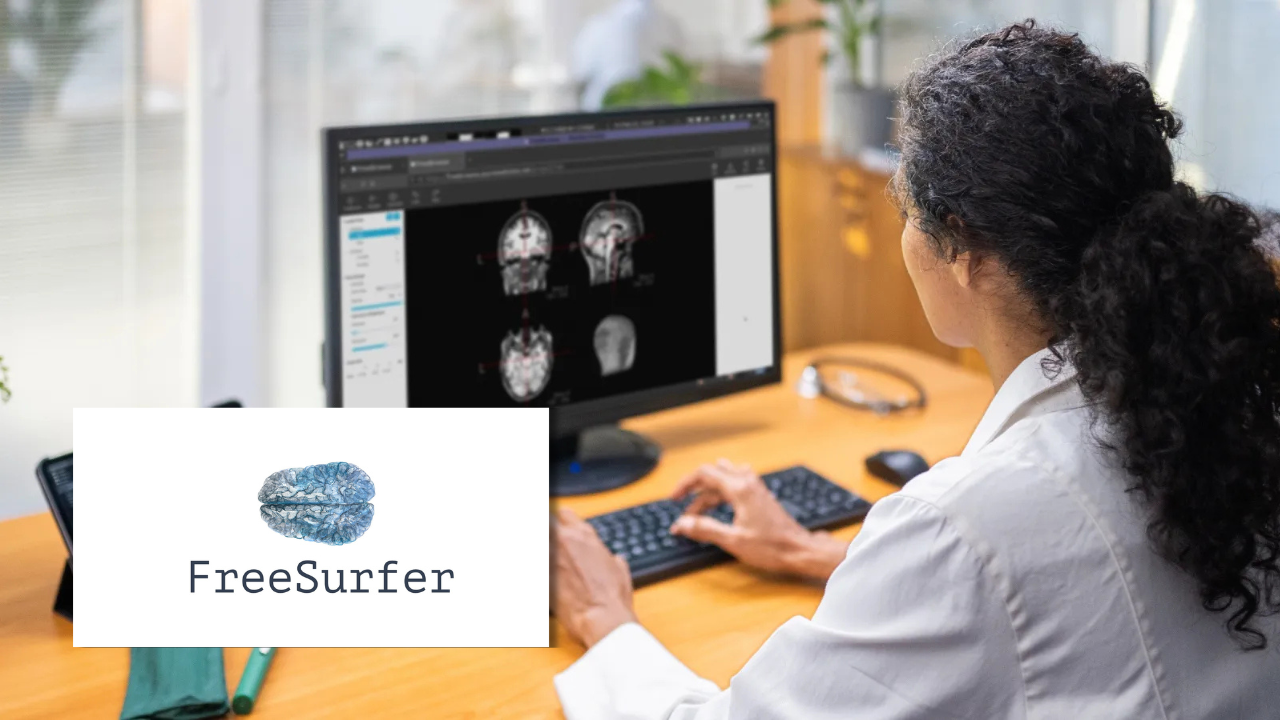 A clinician viewing brain scan images across multiple angles on a computer monitor, next to the FreeSurfer logo.