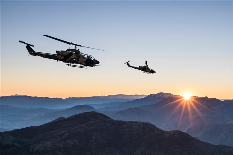 Helicopter flying in the sunrise