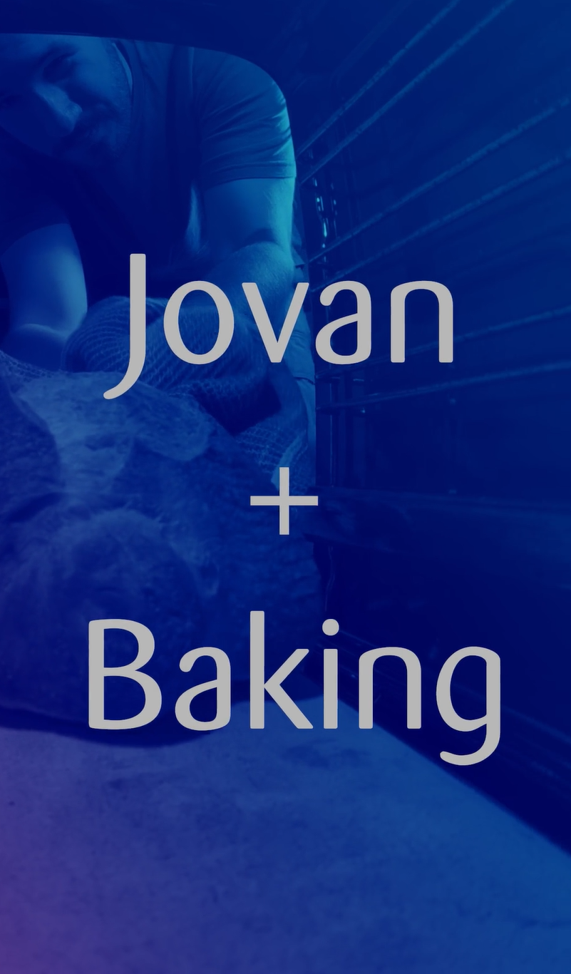 An oven point of view with the bread being pulled out by someone, overlapped by a blue gradiend and a white caption saying Jovan + Baking