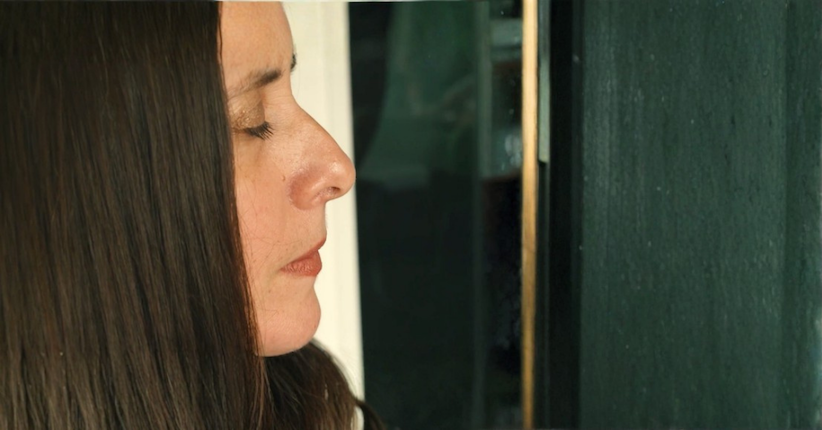 A woman's profile face with the closed eyes