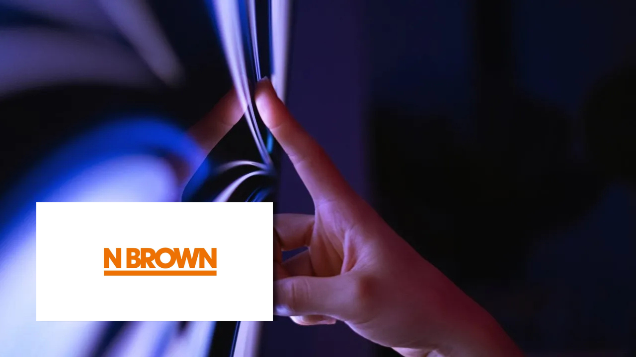 Close-up of a hand touching a reflective, illuminated surface with blue and purple lighting, next to the N Brown logo.