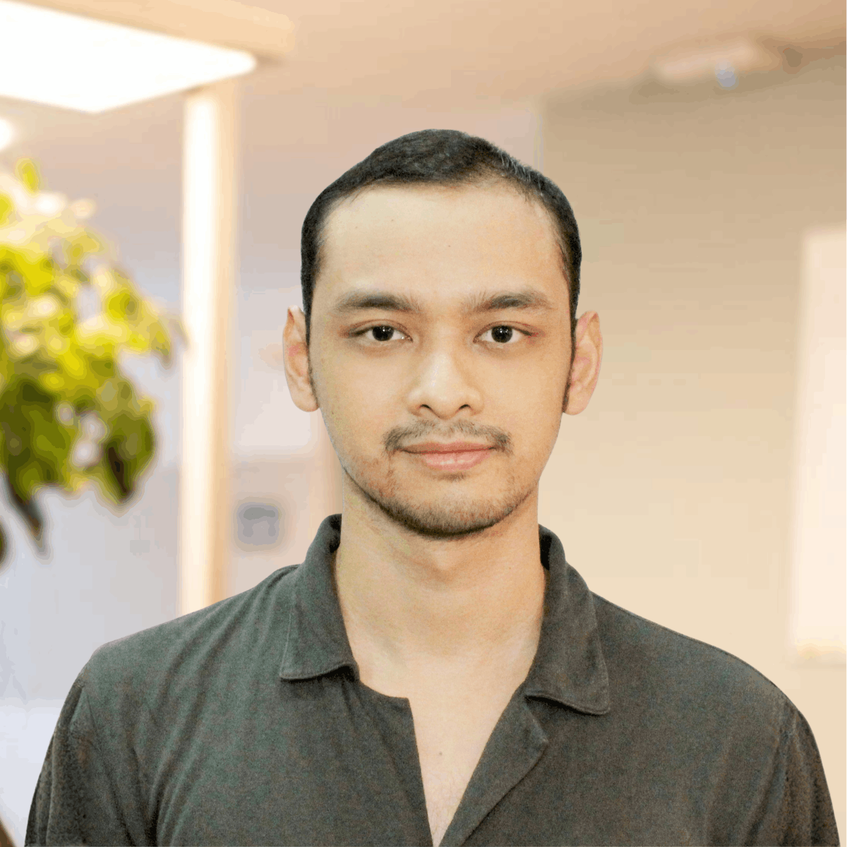 A warm smiling man portrait in a light office setting