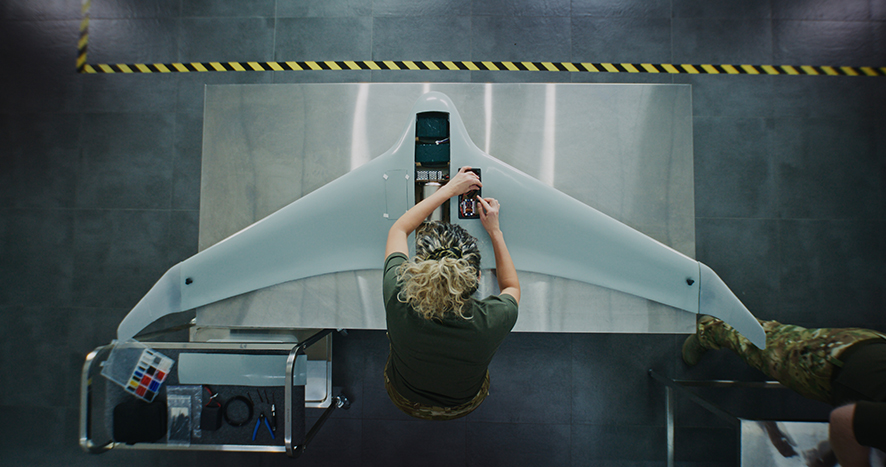 Woman in Camouflage Uniform Working on Next Generation Drone