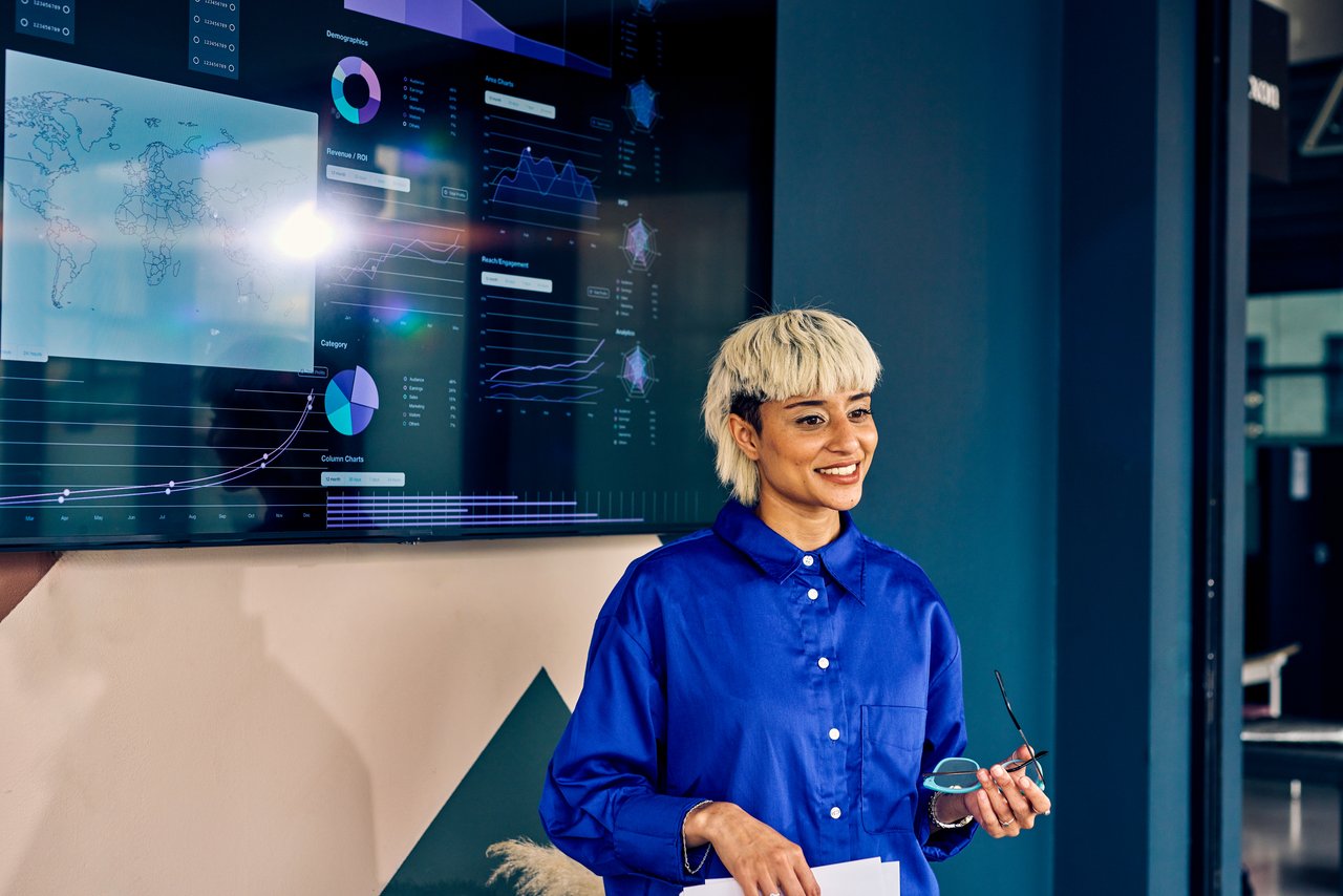 Woman presenting data on a digital display