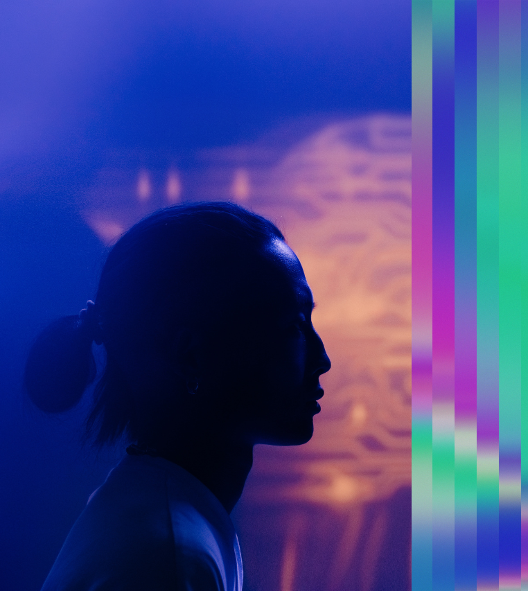 Profile silhouette of a person facing a glowing digital brain, representing human interaction with artificial intelligence.