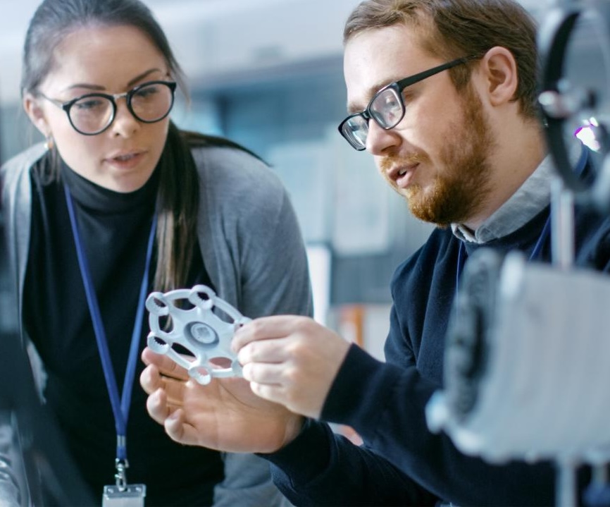 Engineers in a modern laboratory discussing prototype